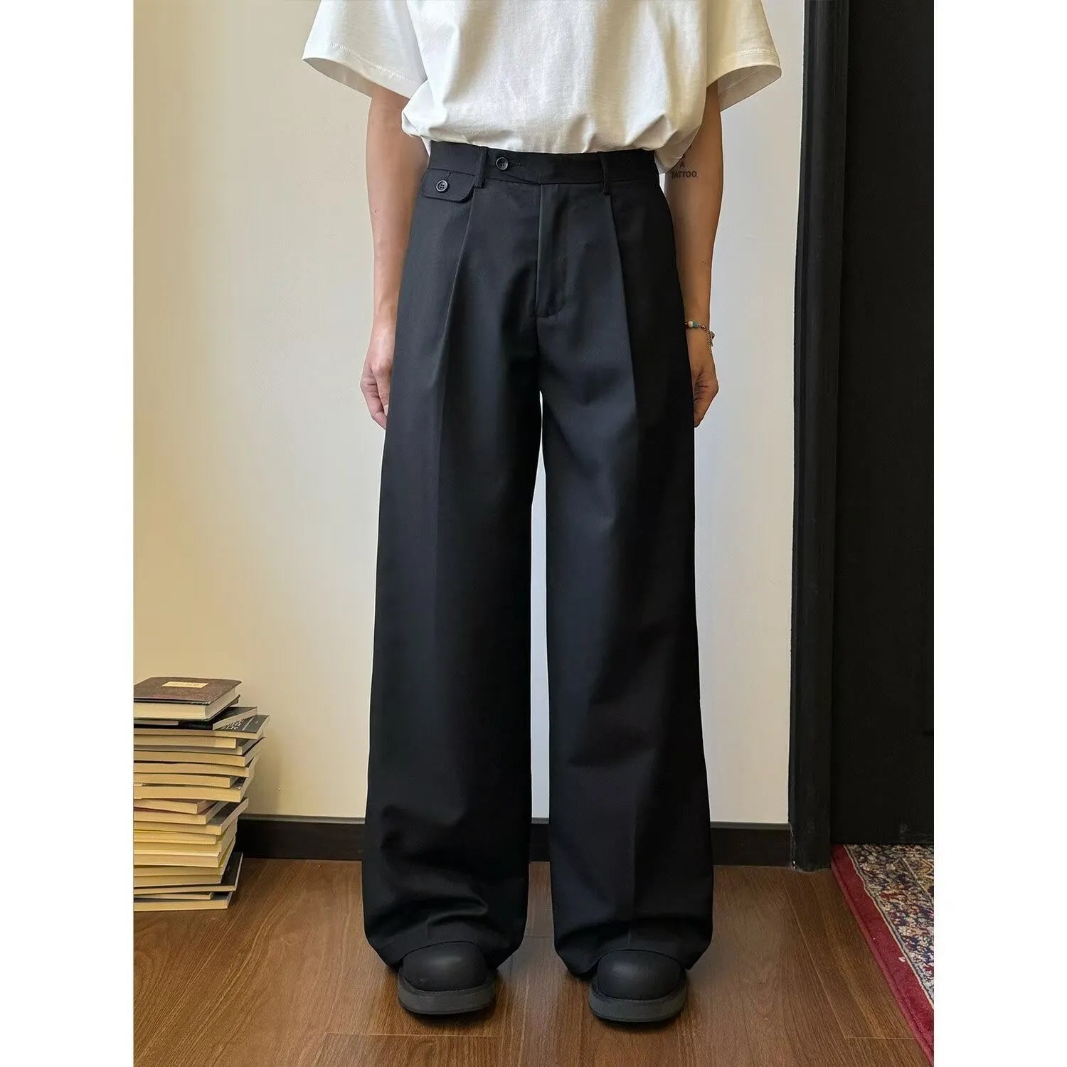 Brown men's wide-leg straight trousers with a draping casual suit style on a hanger.