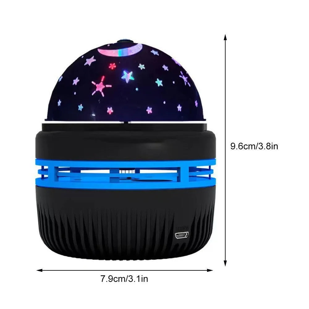 Silver LED galaxy projector lamp with acrylic shade on a table, showing starry light projection on a blue wall.