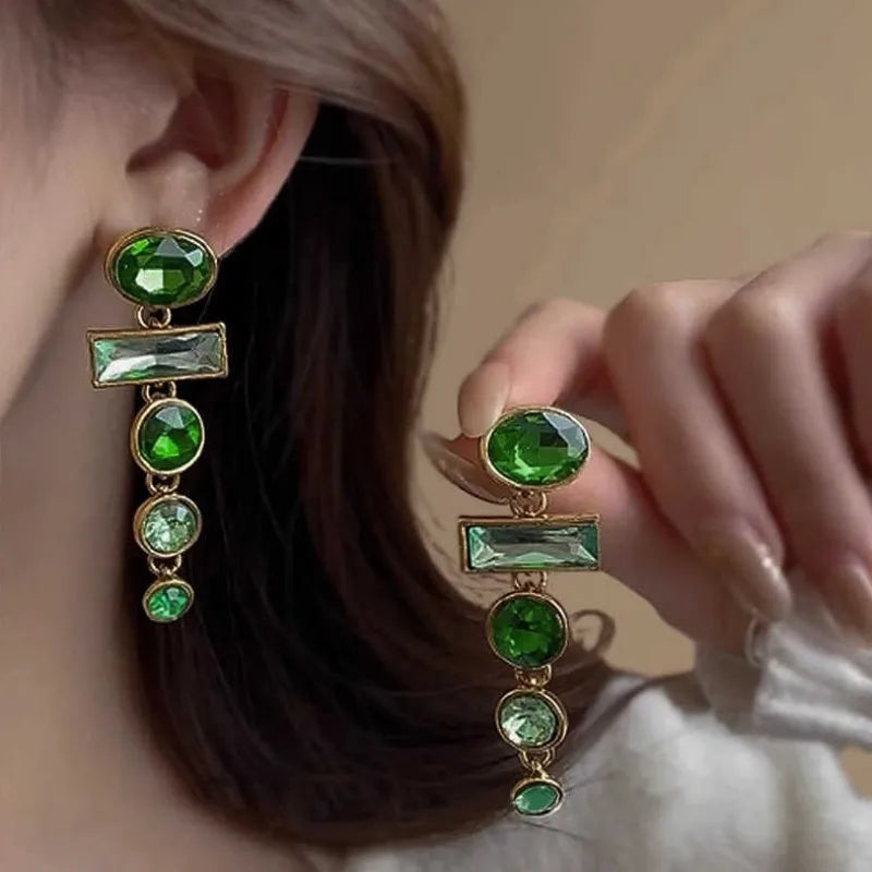 A pair of geometric green gradient alloy earrings with tassel design and inlaid zircon stones.