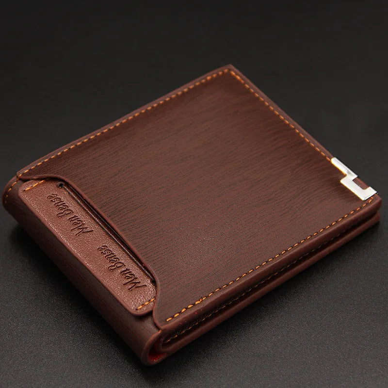 Men's black iron-edge card-picking wallet holding banknotes and cards next to a mobile phone