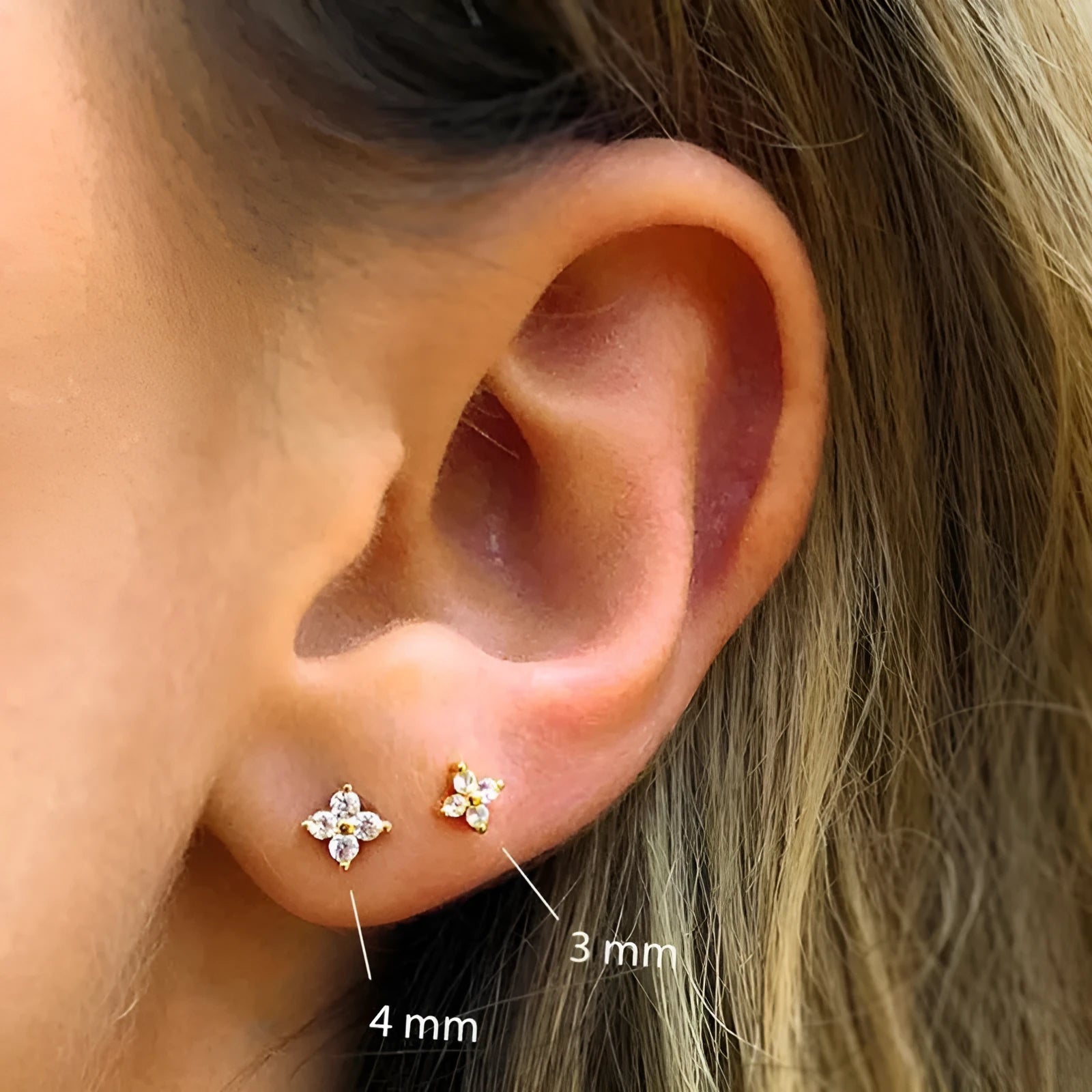 S925 sterling silver petal crystal flowers stud earrings in golden or platinum colour on a white background.