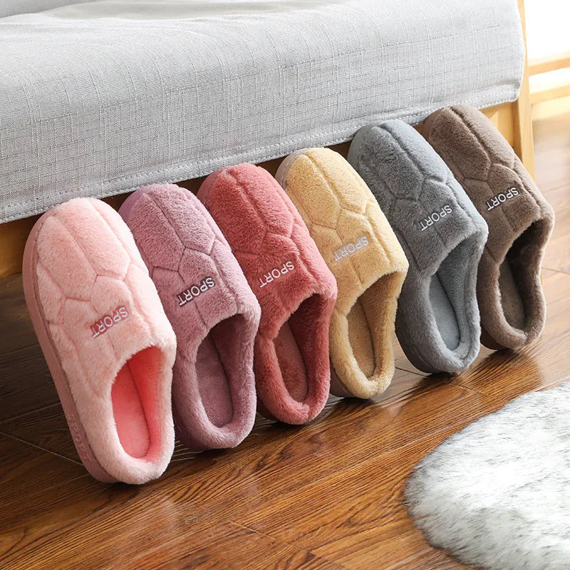 Unisex plush house slippers with white honeycomb-patterned PVC sole, showing round toe and plush inner lining in purple colour