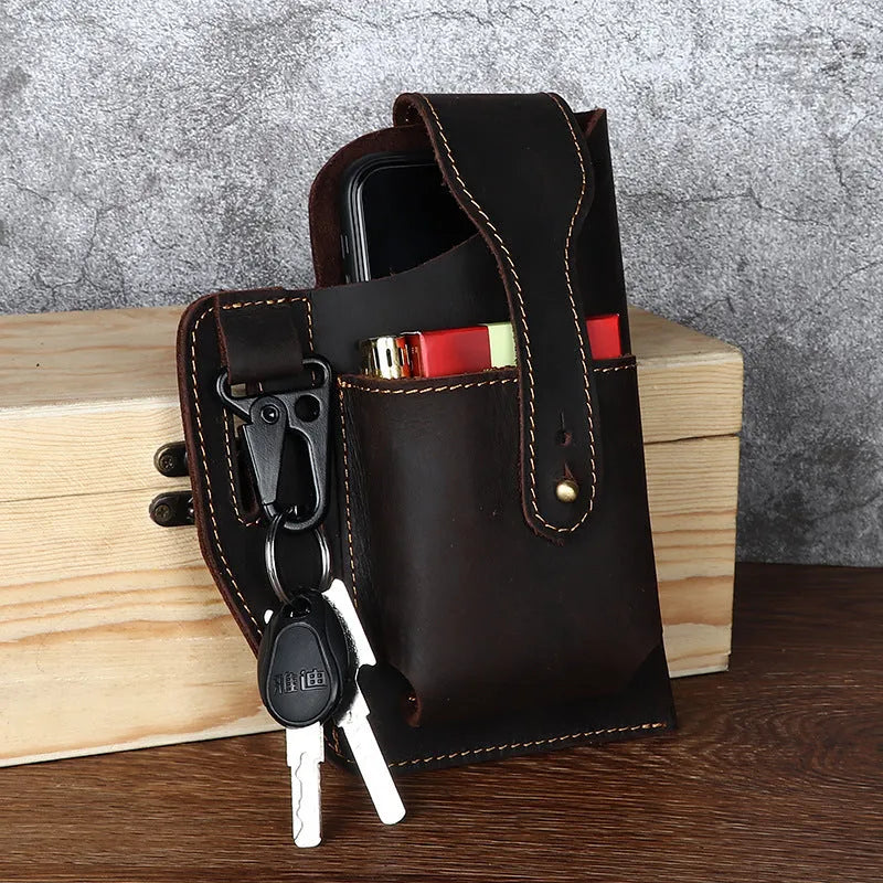 Men's brown leather belt bag with car stitching, shown attached to a belt with phone inside.