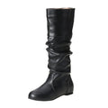 Women's black slip-on flat boots with round toe and high cylinder shaft on neutral background