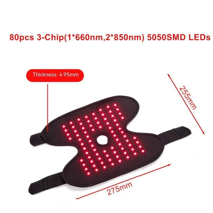 Black fabric ankle support with red light and heating therapy, USB cable, on a flat surface