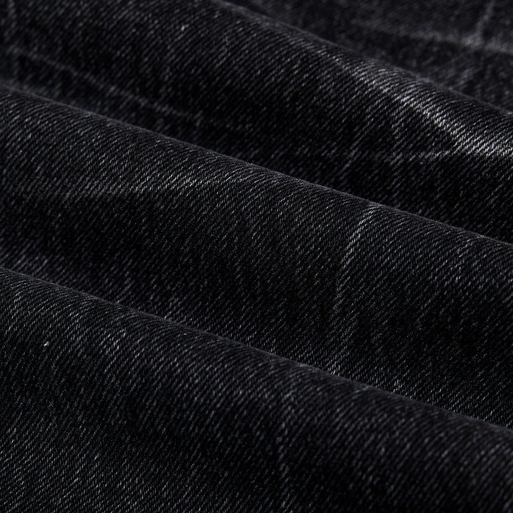 Black men's straight-leg jeans showing a cracked, washed denim finish on a plain background.