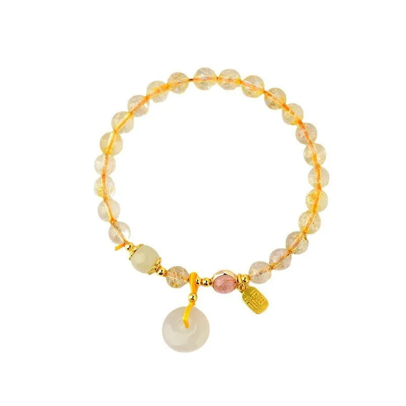 Gold rutilated quartz crystal bracelet with safety buckle closure and geometric pendant