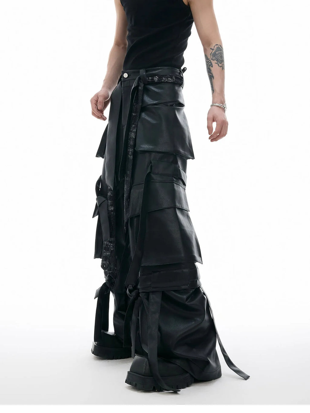 Men's black loose-fit trousers with quilted panels, heavy stitching, and multiple pockets.
