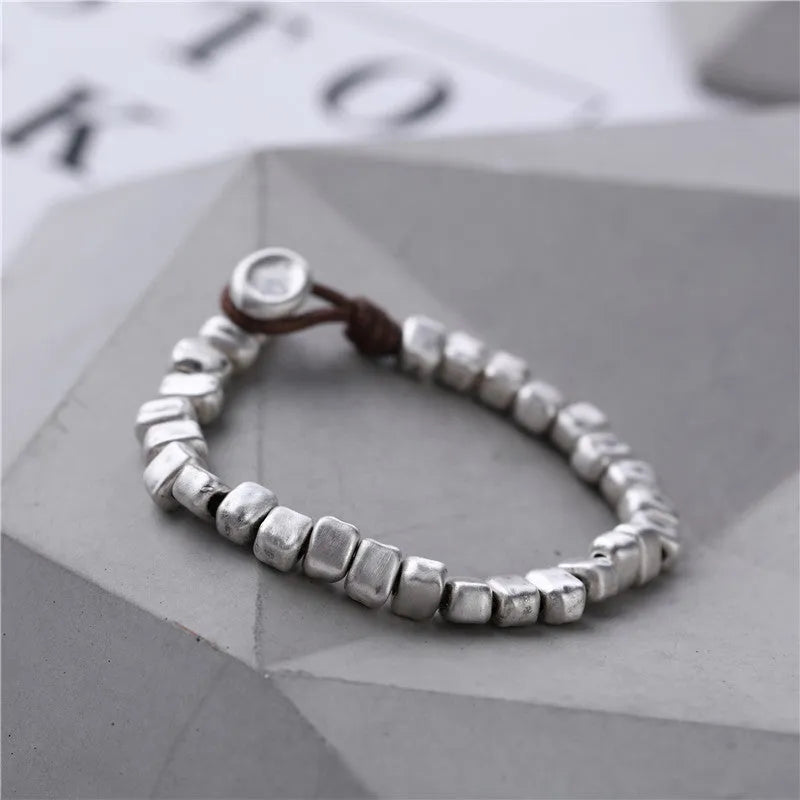 Handmade women's bracelet with irregular silver squares on wooden beads and elastic band