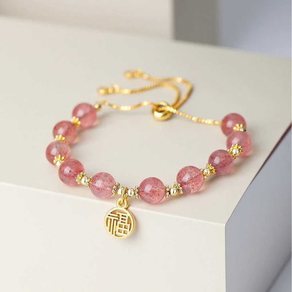 Women's strawberry quartz crystal bracelet with geometric design and fu character element