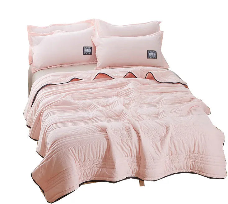 Pure colour seersucker cooling air-conditioning quilt laid flat on a bed