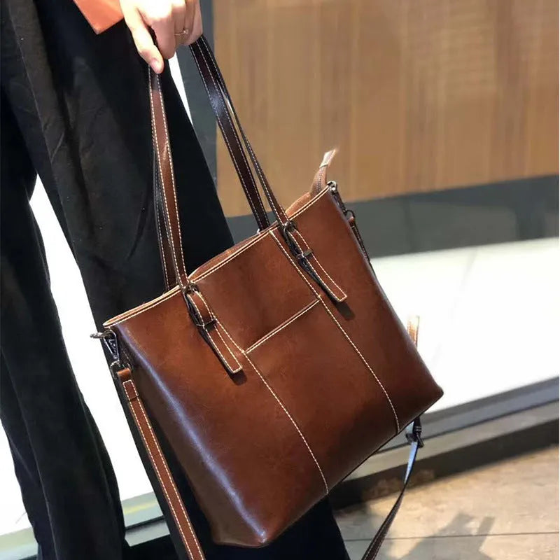 Genuine leather women's retro shoulder bag in brown with multiple compartments and straps