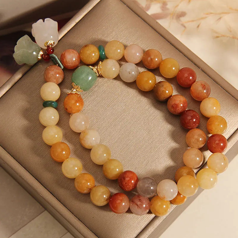 Natural jade multi-layer bracelet for women with an orchid pendant on an adjustable fastening.