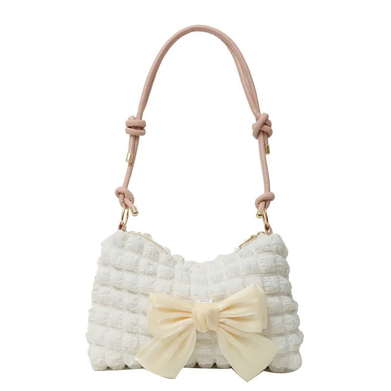Women's canvas handbag with single shoulder strap in horizontal square shape showing mobile phone compartment