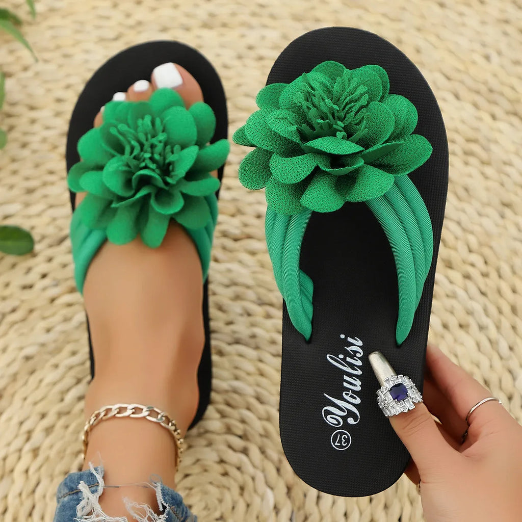 Solid-colour floral flip-flops with a lightweight EVA sole on a plain background.