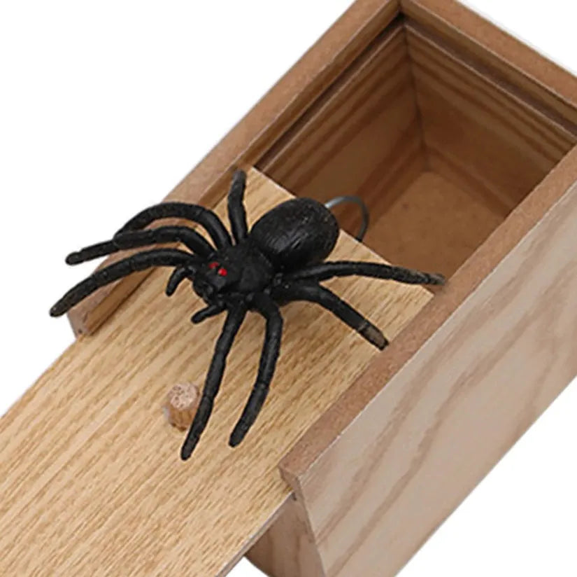 Wooden prank scare box with lid open showing a lifelike spider figurine on a spring.