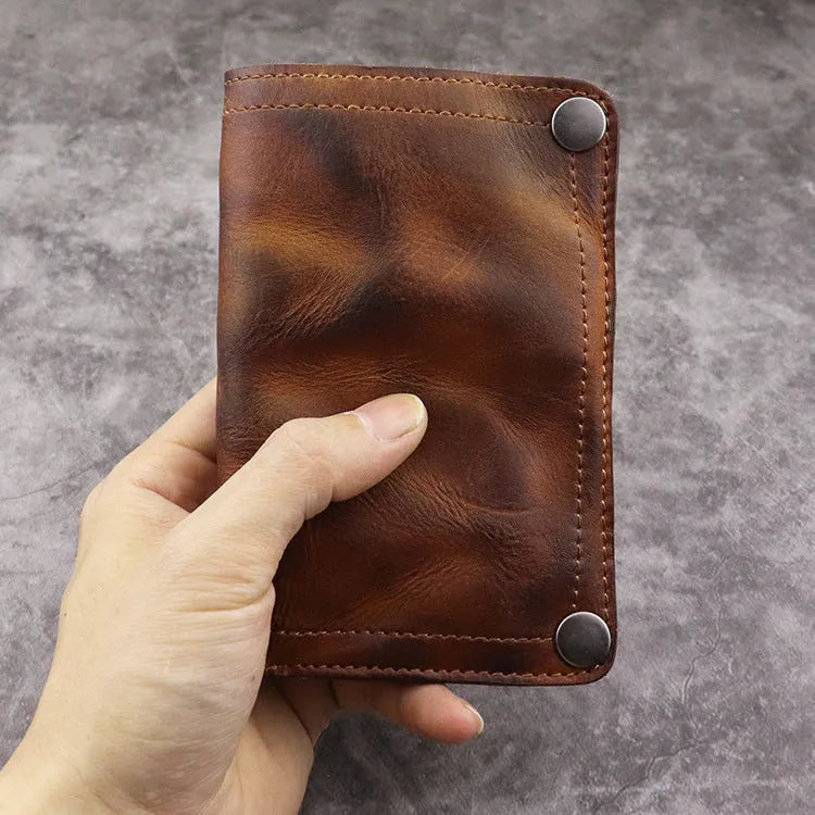 Men's retro brown genuine leather vertical wallet open showing card slots and coin pocket.