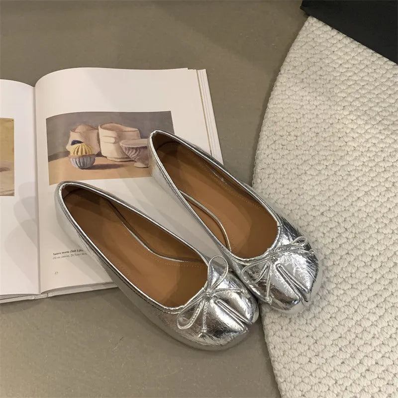 Women's split-toe flat pump shoes in beige with a round toe and shallow cut.