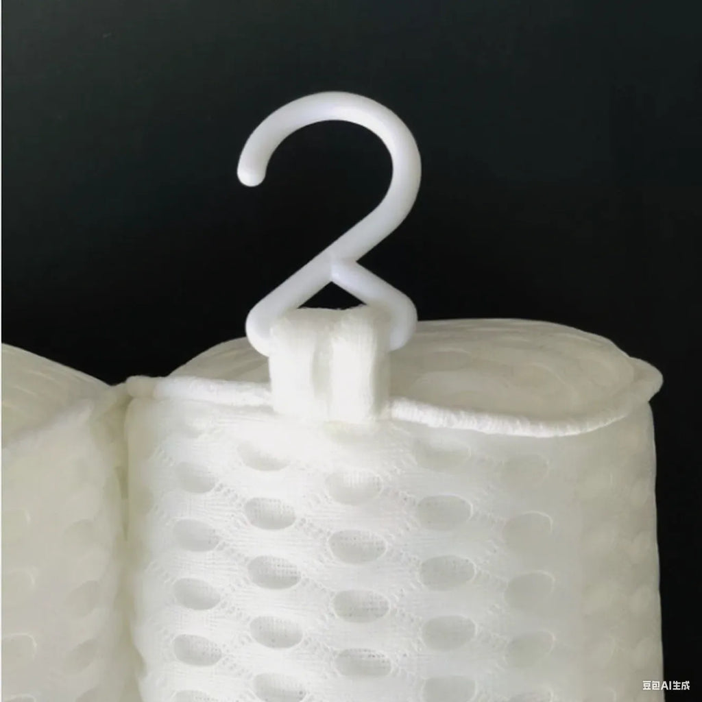 White 4D mesh bathtub pillow with suction cups on a bathtub edge.