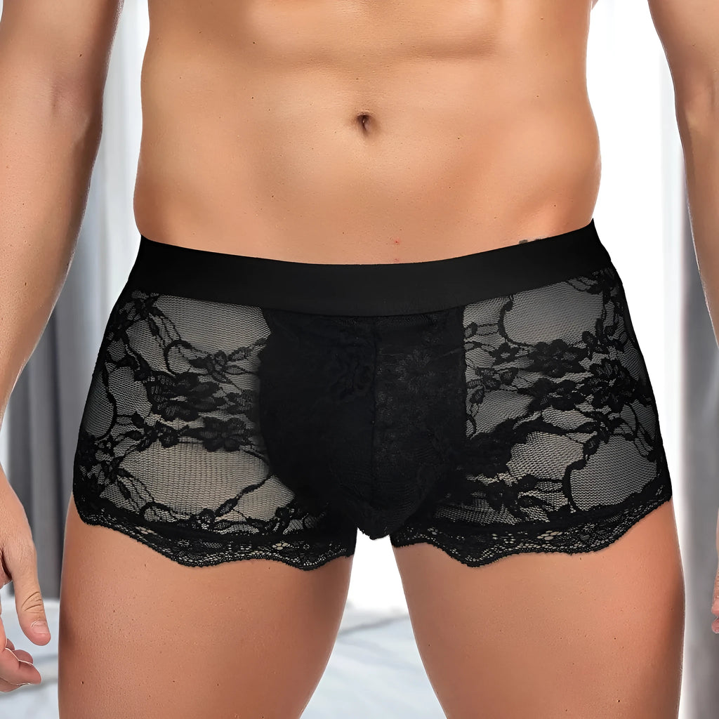 Men's black lace briefs with hollow-out see-through design on white background