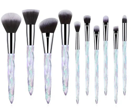 Ten crystal-handle foundation brushes with artificial fibre bristles in black, blue, red, and yellow colours.