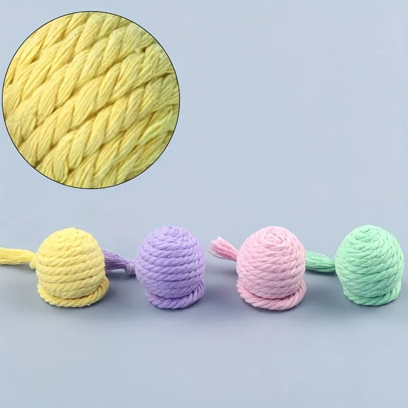 Colourful cat toy ball with rope attached and internal bell for kitten play stimulation