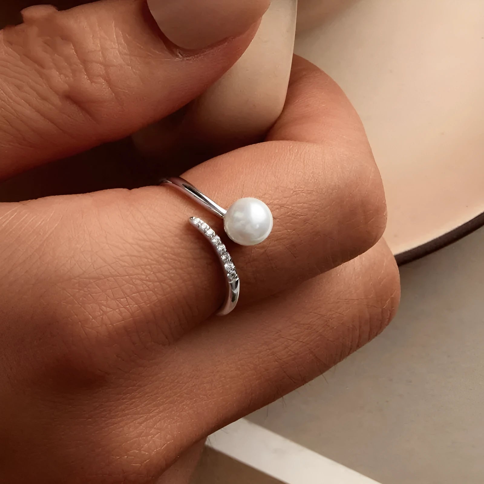 Adjustable S925 sterling silver ring with a pearl on an open-loop band.