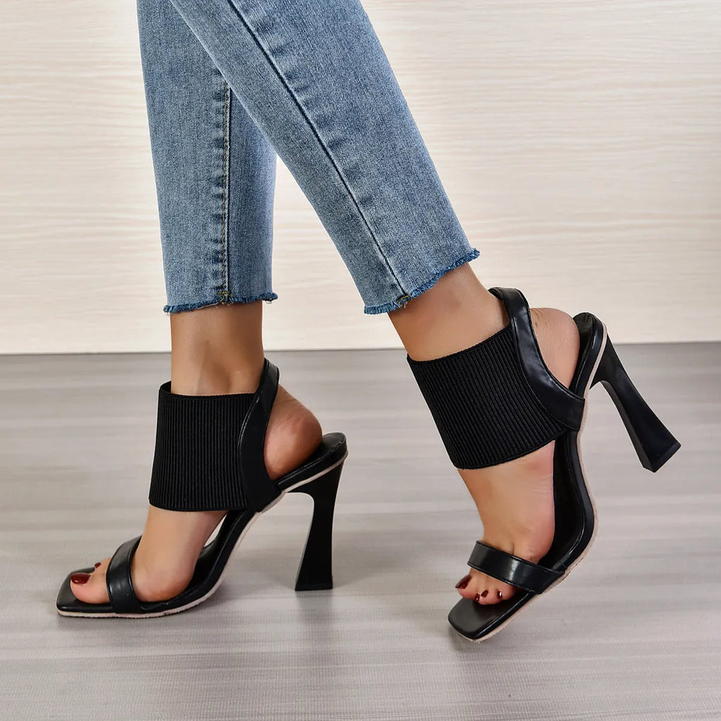 Women's black high heel sandals with elastic straps and rubber sole