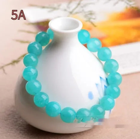Natural blue-green Amazonite 7A grade scattered beads bracelet on a white background.