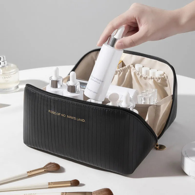 Vertical pattern cubic PU leather makeup bag in beige, shown open to display large capacity interior.