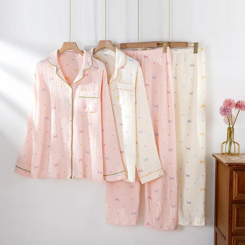 Women's cotton pajama set with long sleeves in pink colour showing top and trousers laid flat