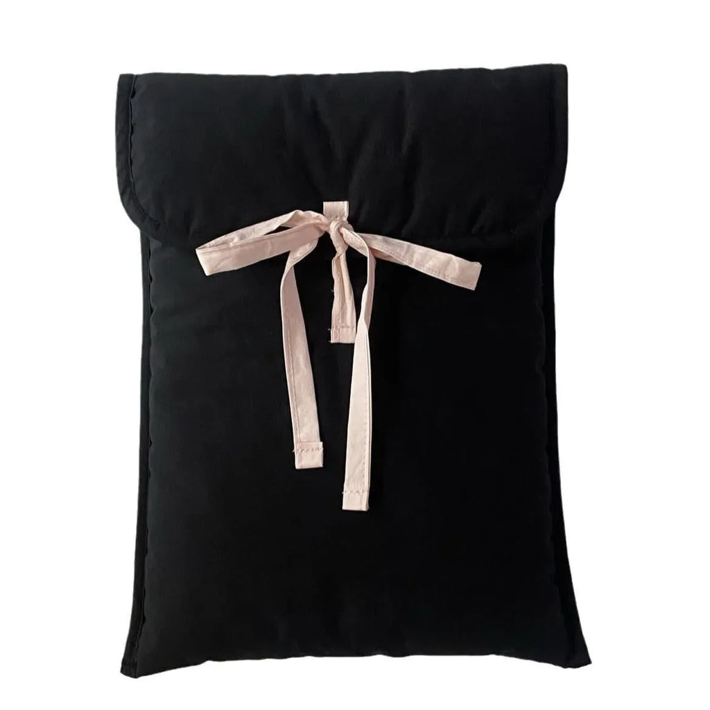 Women's black and white quilted ballet style laptop bag with bow, shown in two sizes.