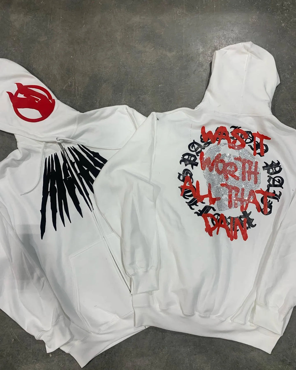 Black loose hooded sweatshirt with white skull and letter print decorated with silver rhinestones.