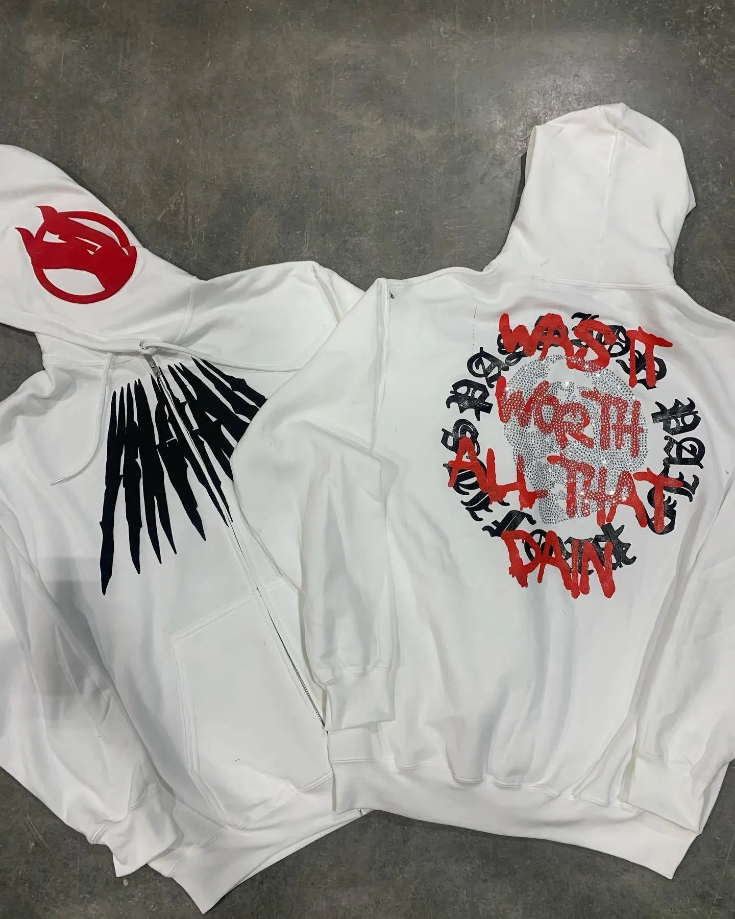 Black loose hooded sweatshirt with white skull and letter print decorated with silver rhinestones.