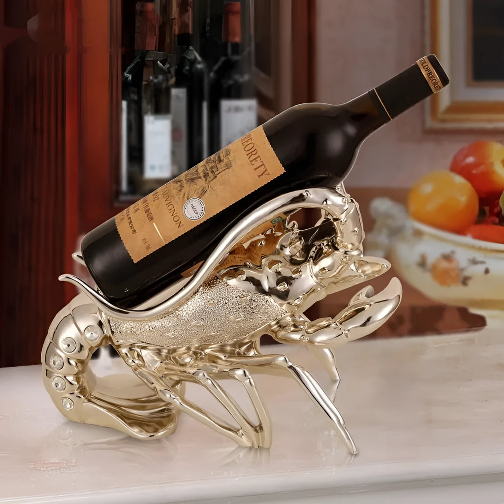 Decorative lobster-shaped wine rack ornament in rose gold or silver resin and plastic on a tabletop.