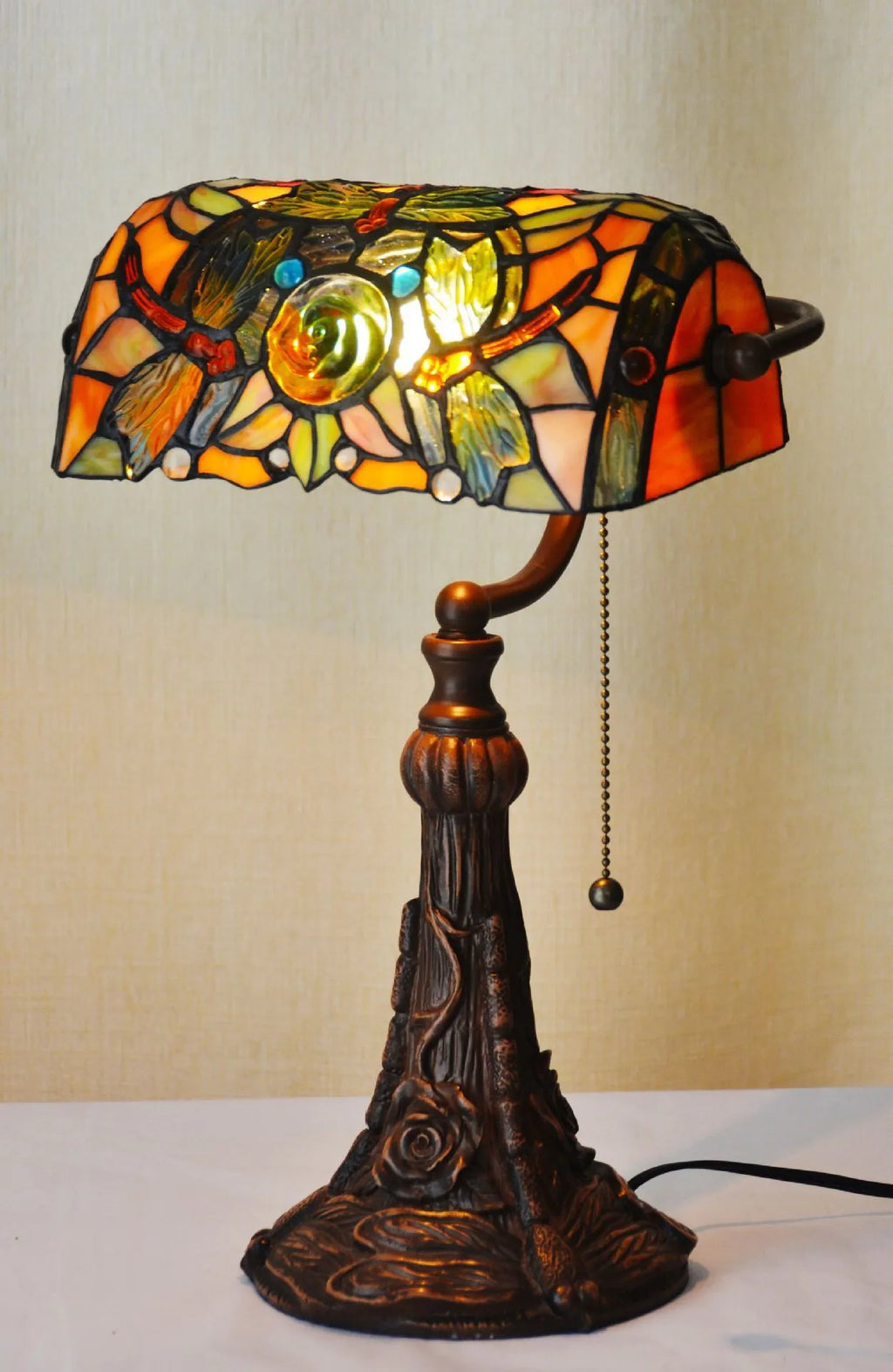 10-inch Tiffany stained glass table lamp with multicoloured glass and resin base on desk