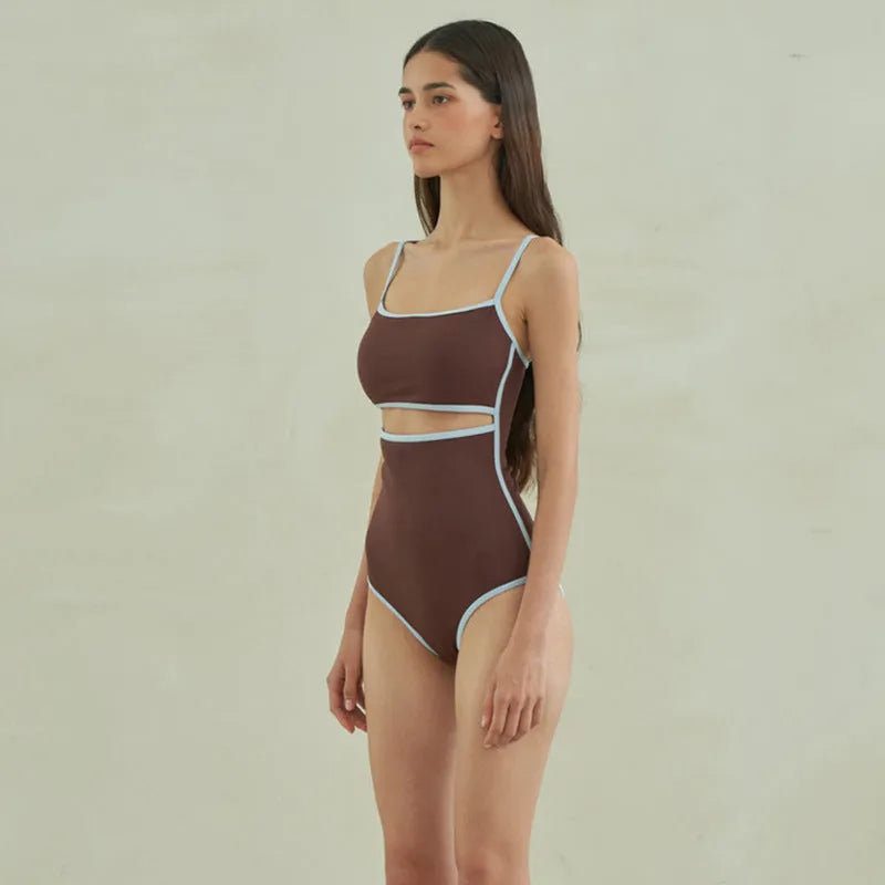 Brown women's one-piece swimsuit with triangle top design on a mannequin