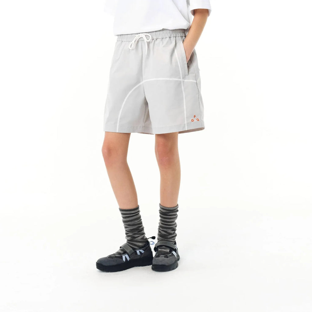 Dark grey high elasticity polyester drawstring shorts with loose fit on a beach background