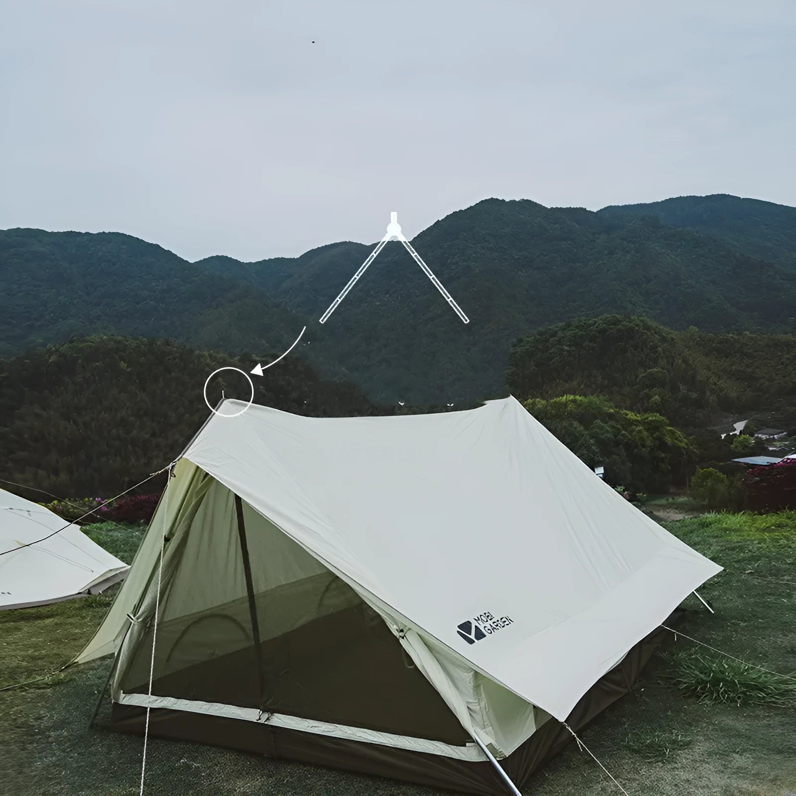 Large light luxury family camping tent in ivory white with cotton-polyester outer and aluminium poles set up outdoors