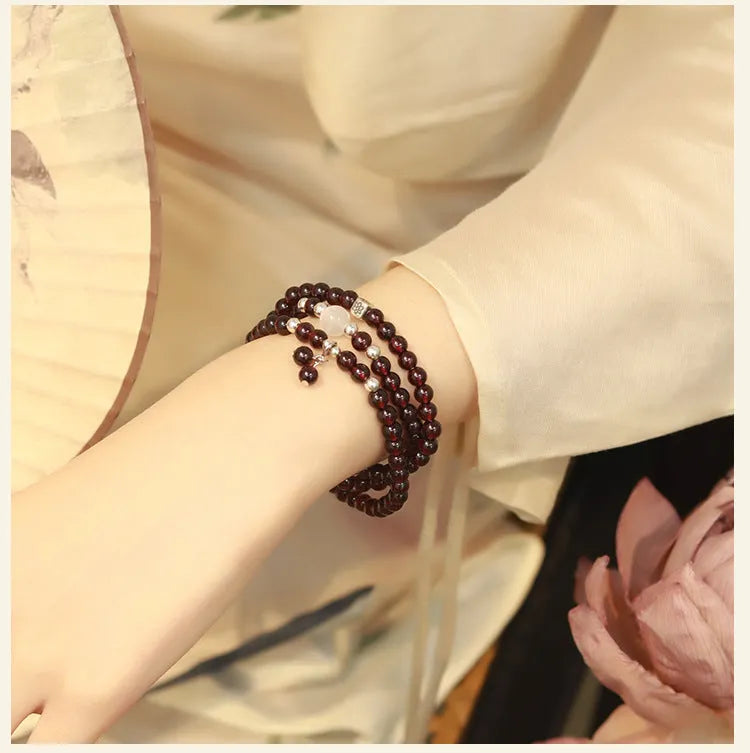Chinese-style garnet bracelet with U-shaped design and pomegranate elements in antique style