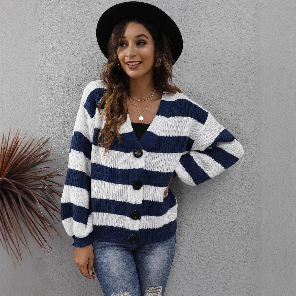 Woman wearing a blue striped cardigan sweater with buttons, showcasing the deer plush fabric texture.