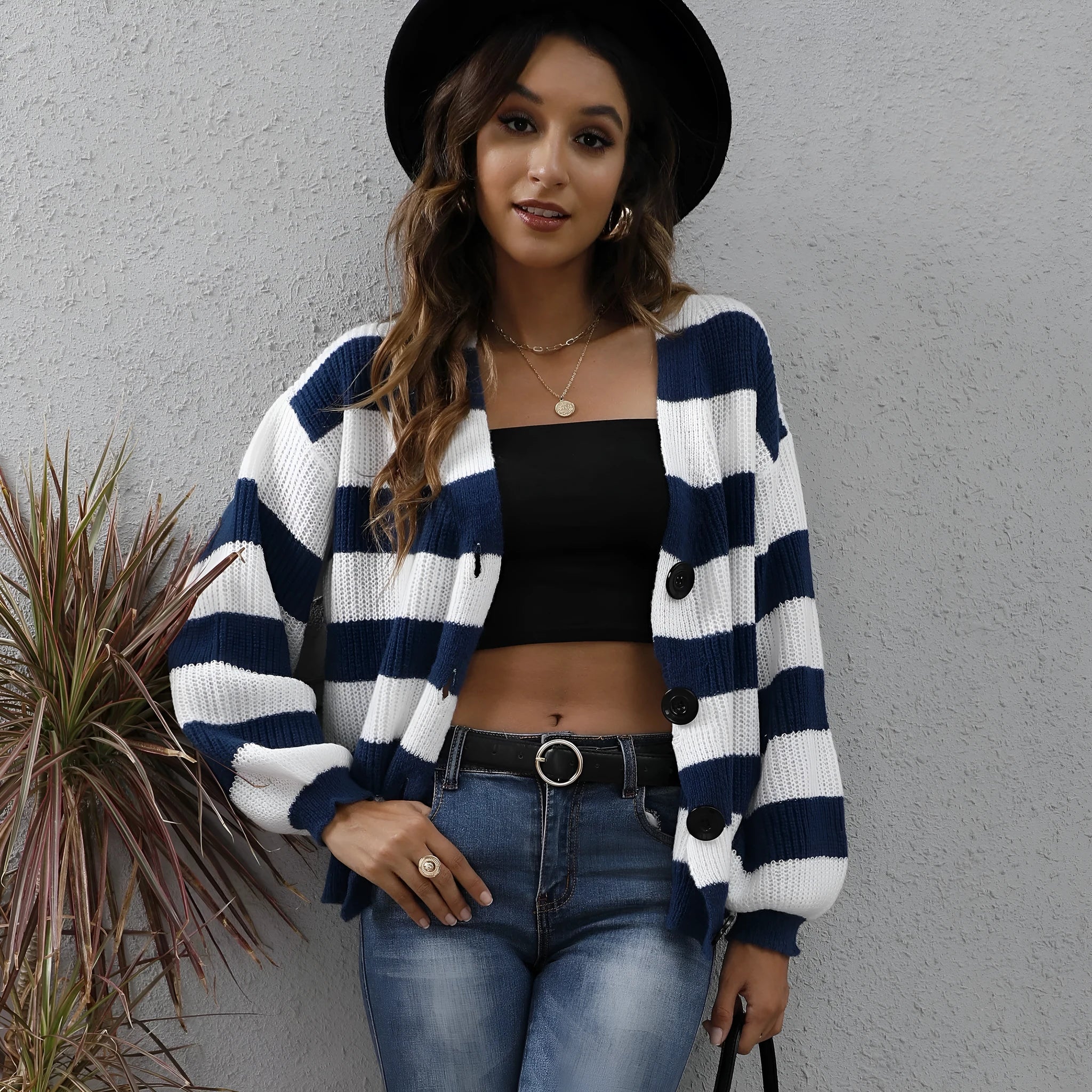 Woman wearing a blue striped cardigan sweater with buttons, showcasing the deer plush fabric texture.