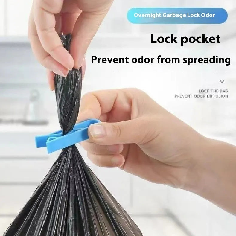 Green and black non-slip plastic clip for holding a bin bag on a wheelie bin rim.