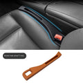 Black car seat gap storage box organiser with handle placed between vehicle seats