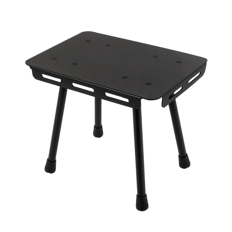 Aluminium alloy dual-use folding camping stool and table with green cushion.