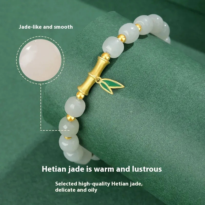 Natural Hetian jade and sterling silver bamboo leaf bracelet on a wrist, showing gold and silver finish options.