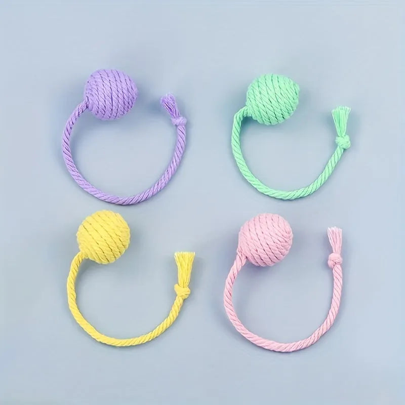 Colourful cat toy ball with rope attached and internal bell for kitten play stimulation