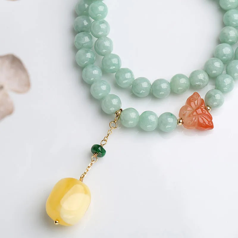 Close-up of a double-layer women's bracelet with green jade round beads and brown beeswax barrel beads in a geometric design.