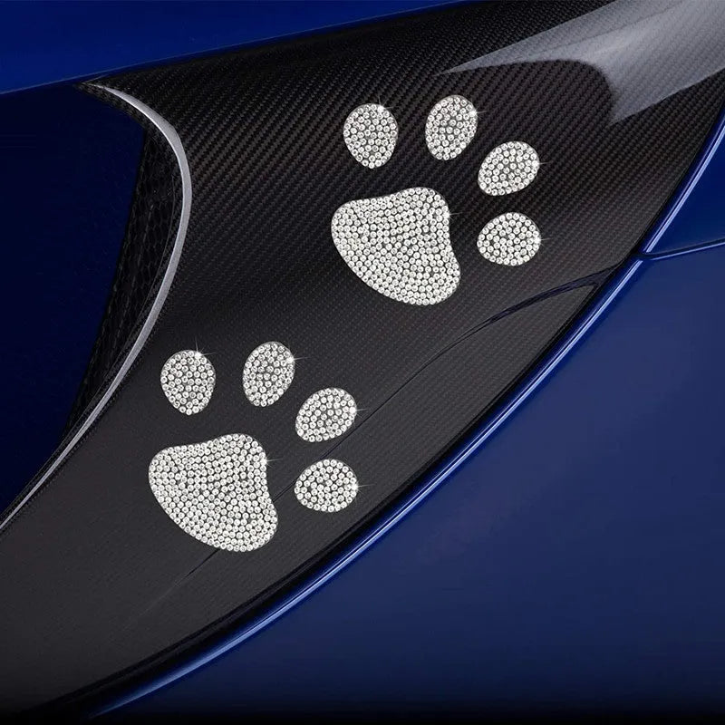 Close-up of a diamond-encrusted bear paw and butterfly design on a 7x6cm glass car sticker.