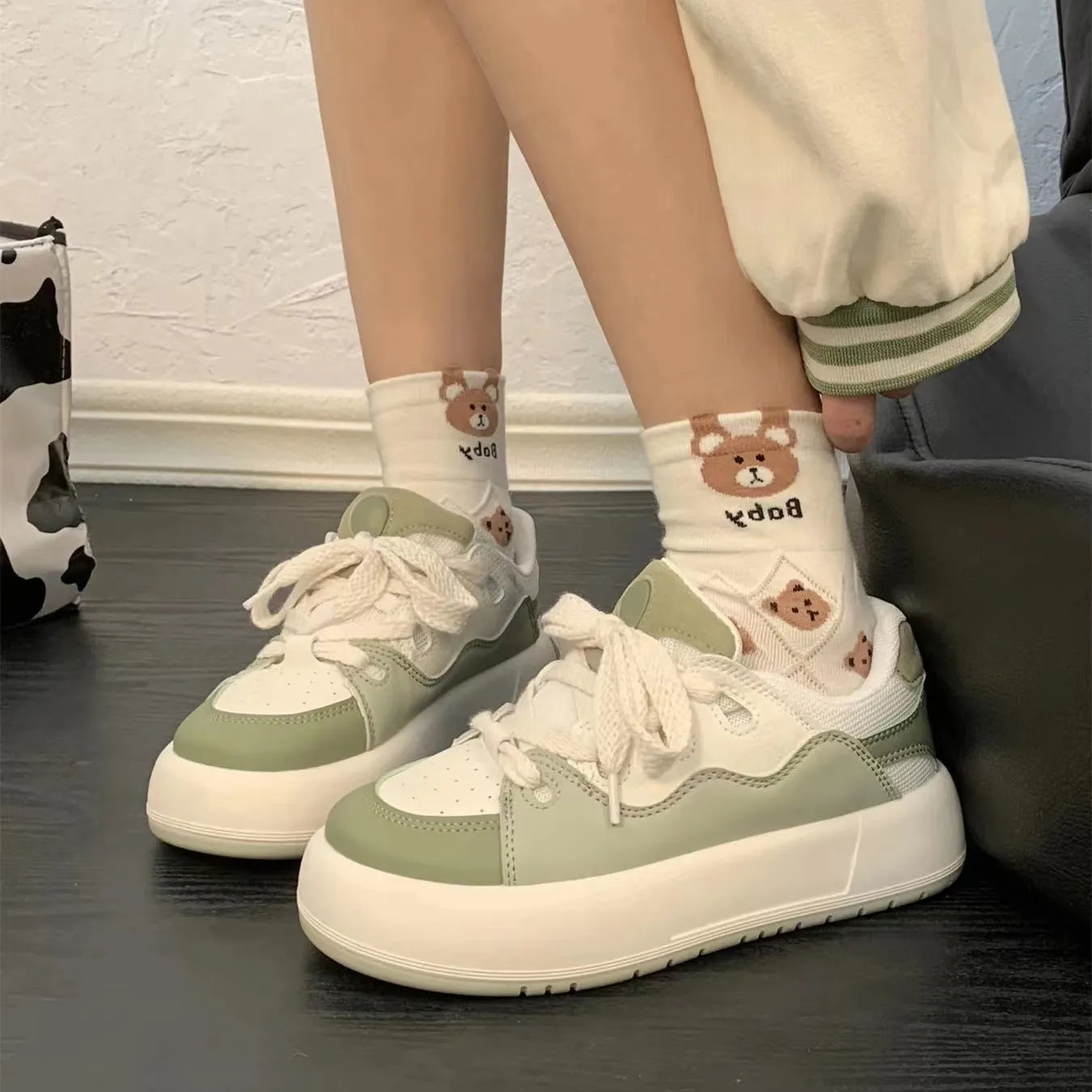 Green women's casual shoes with mesh upper, flat heel, and round toe design